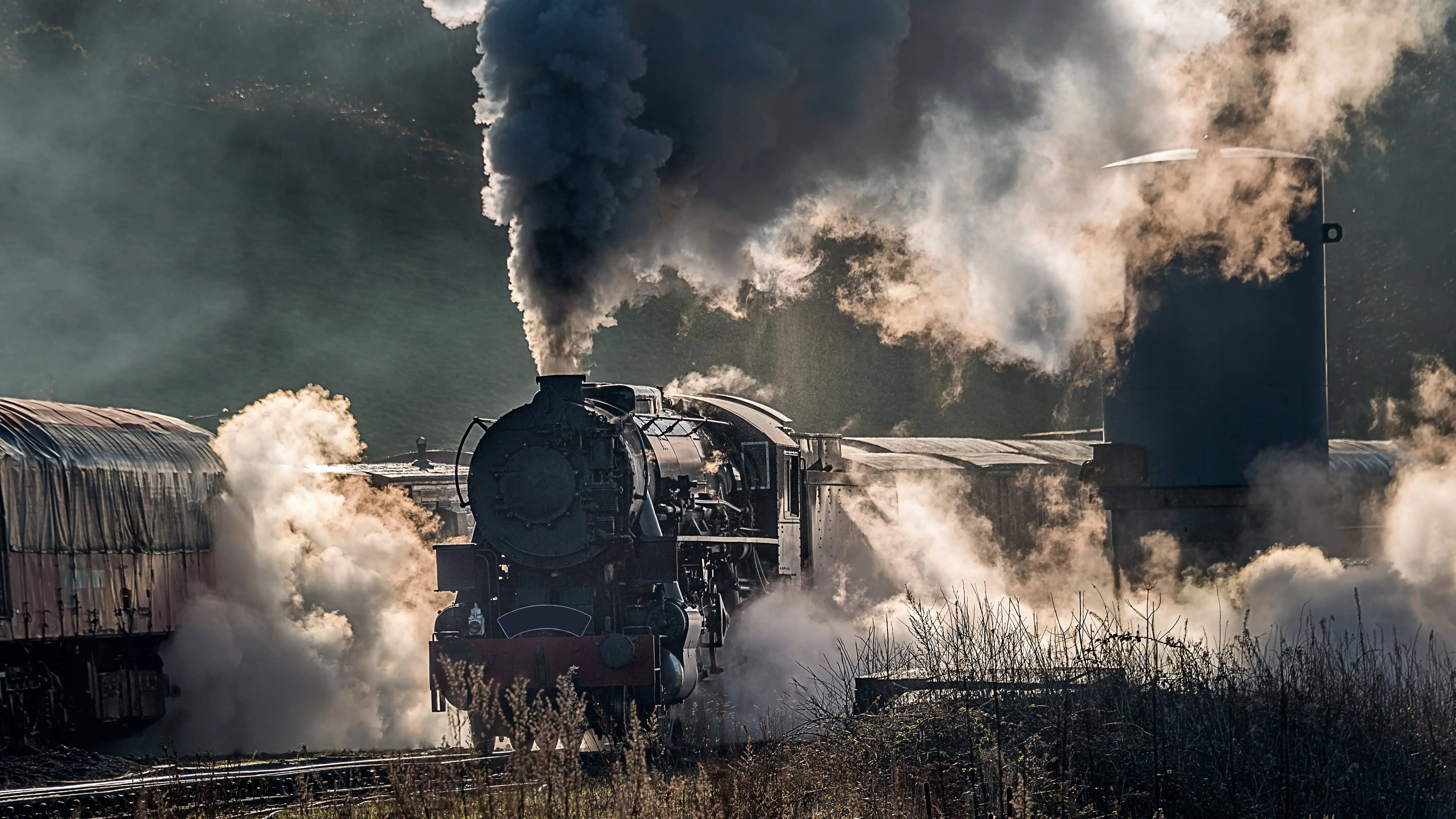 Steam Train: A steam locomotive approaching a station.