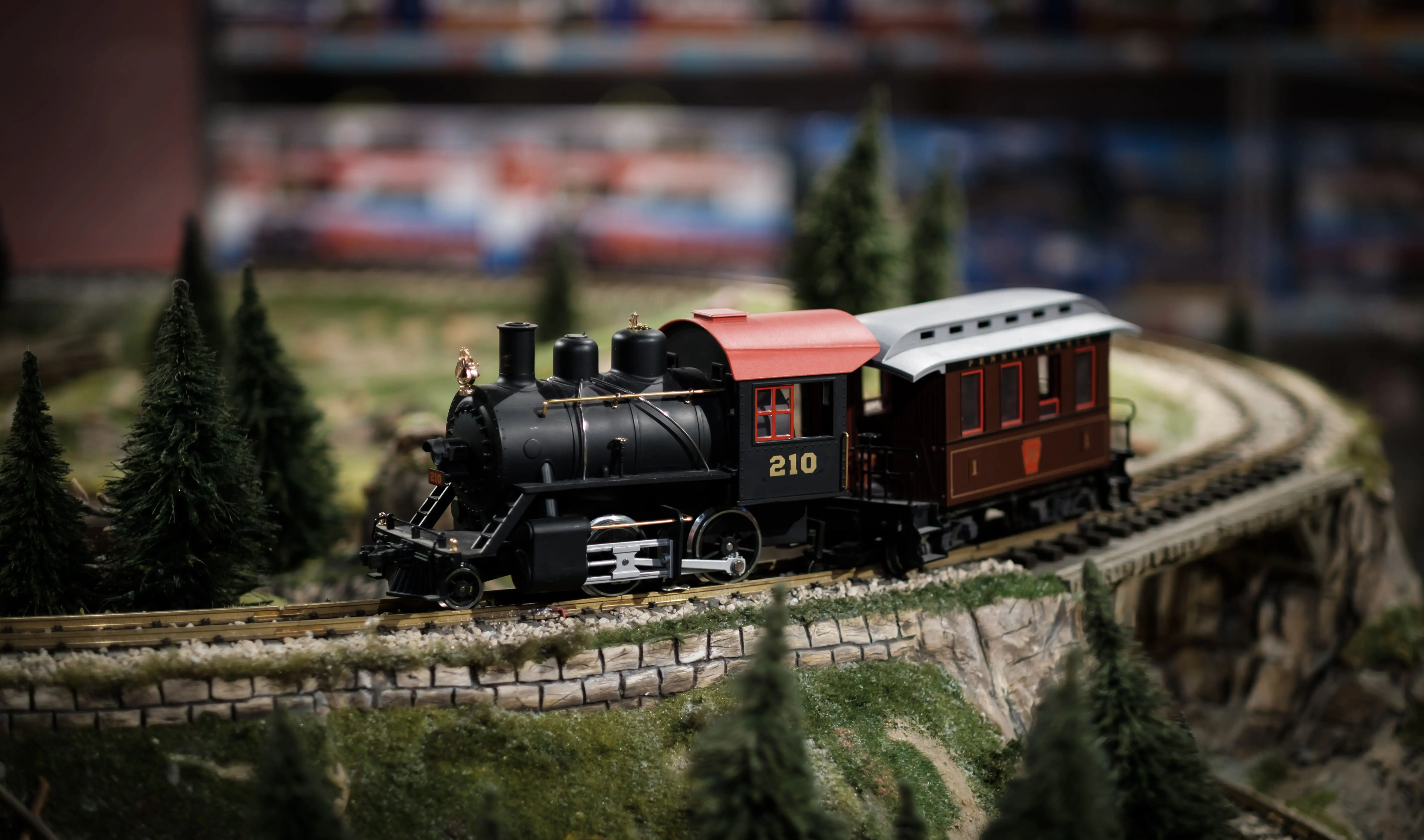 Famous Train Spotters: A close-up of a model steam train going along a model railway track.